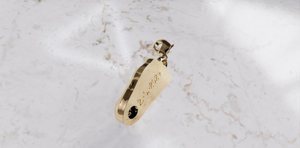 Babyvoetje bedel in goud met askamer aan achterzijde herdenkingssieraad sterrenkind