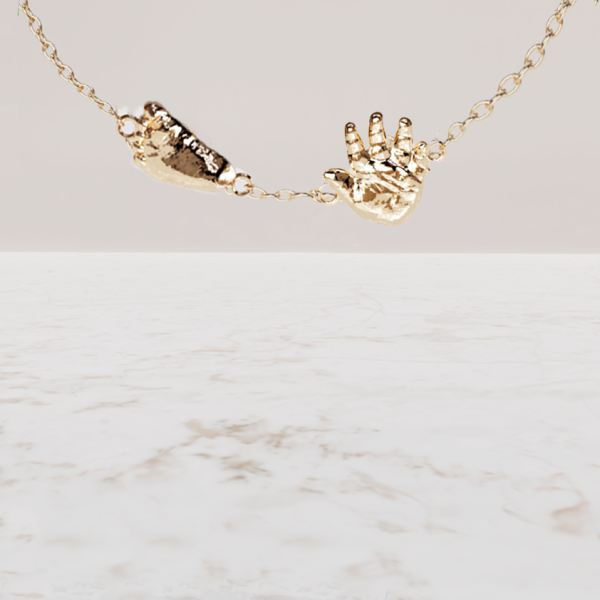Collier handje voetje baby in goud